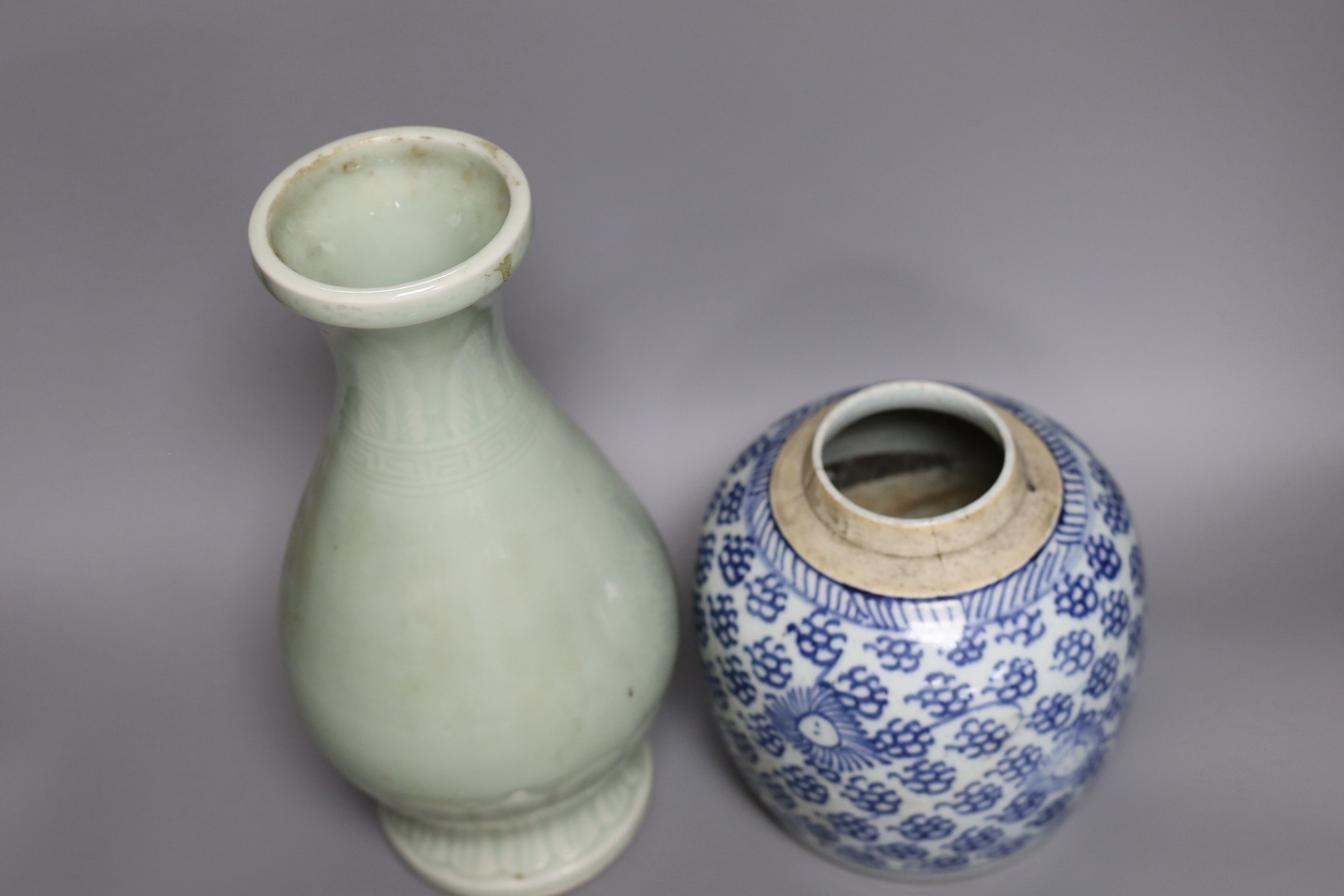 A Chinese celadon ground vase and a similar blue and white jar, tallest 30cm